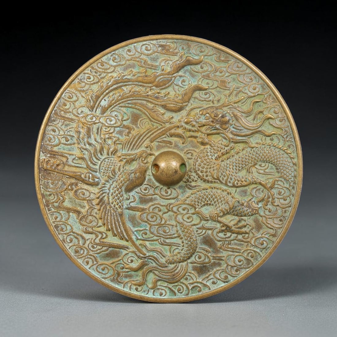 A Chinese Bronze Mirror with Dragon and Phoenix among Clouds Relief, 23AJ (1 of 2)