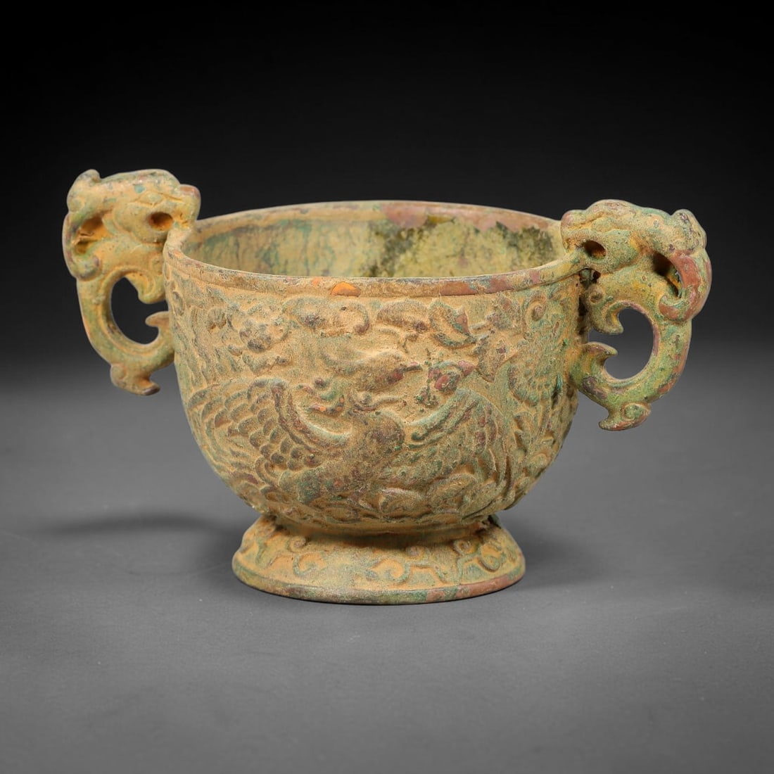 A Chinese Archaic-Style Bronze Two-Dragon-Handled Cup with Phoenix Relief, 77AD (1 of 3)