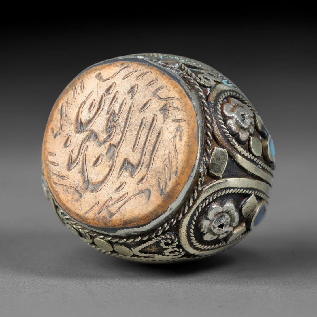 Vintage Islamic Handcrafted Silver Plated Calligraphic Talisman Statement Ring, 41AJ: This vintage hand-wrought Islamic statement ring features a central engraved panel bearing traditional calligraphic detailing, set within an ornate silver-plated metal band. The mounting is enriched w
