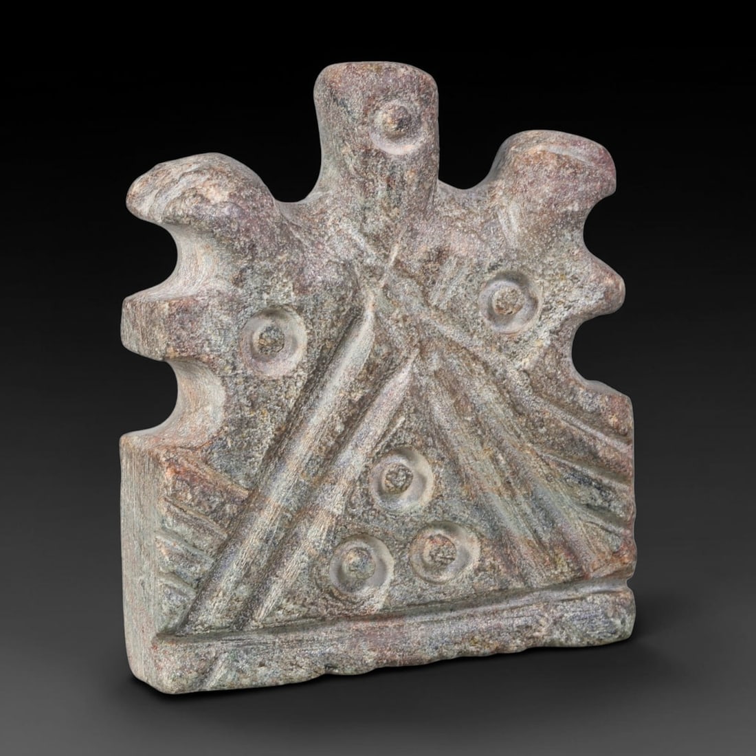 Ancient Sasanian Persian Hard-Stone Symbolic Apotropaic Plaque (224-651 CE), 47AJ: Hard-stone ritual plaque of Sasanian Persian origin, adorned with carved intersecting linear motifs and multiple drilled circular symbolic emblems across its face. The outer edge features stylized pro