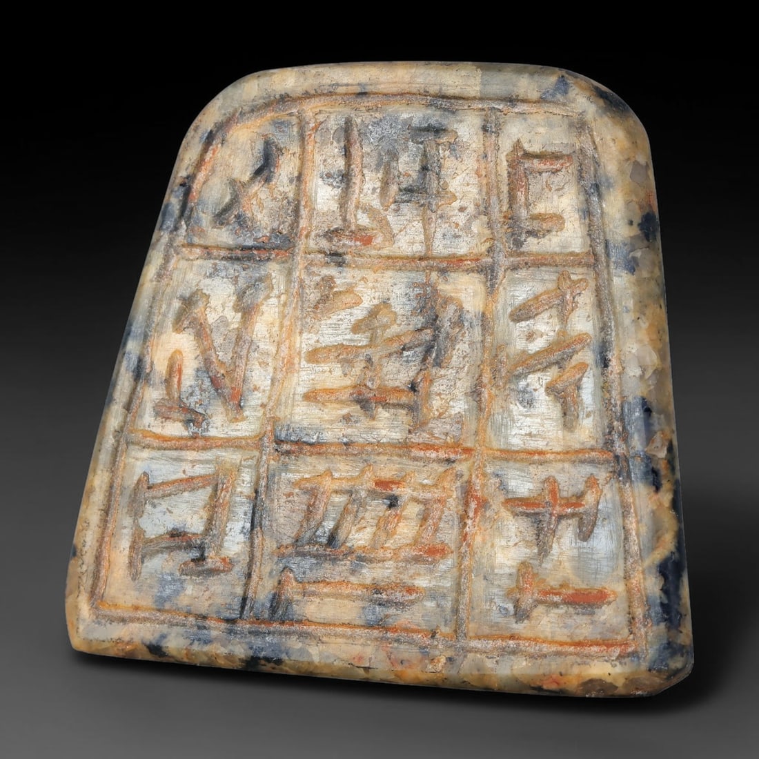 Ancient Old Babylonian Mesopotamian Inscribed Talisman Plaque (c.1900-1600 BCE), 61AJ: Hard-stone talismanic plaque of Old Babylonian Mesopotamian origin, its surface divided into a grid of carved compartments filled with stylized symbolic glyphs. Traces of ancient red pigment remain pr