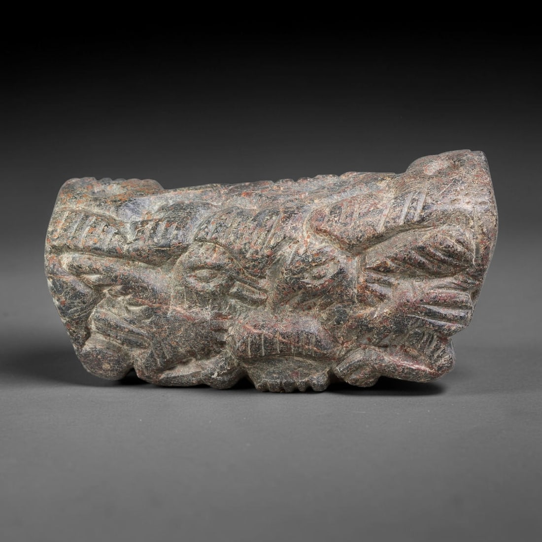Ancient Achaemenid Persian Schist Zoomorphic Composite Amulet (550-330 BCE), 69AJ: Carved dark schist amulet of Achaemenid Persian origin, displaying densely packed composite zoomorphic relief carving across its face. Multiple stylized creature forms are interwoven within the compac