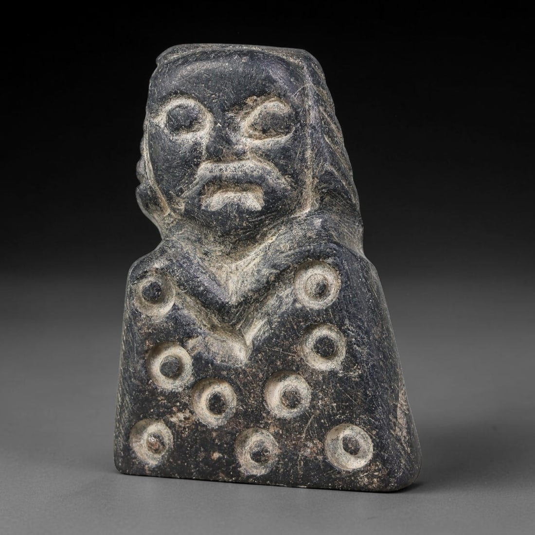 Ancient Sasanian Persian Schist Anthropomorphic Idol Amulet (224-651 CE), 51AJ: Carved dark schist talismanic bust-form idol characteristic of Sasanian Persian folk ritual craft. The figure displays stylized facial features with defined hair framing the head, the chest area decor