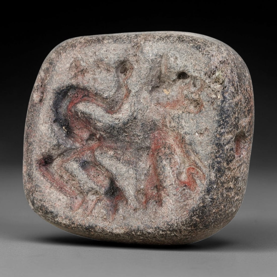 Ancient Elamite Civilization Double-Sided Intaglio Stone Bead (3200-539 BCE), 96AJ: This double convex intaglio stone bead originates from Elamite Civilization, featuring two distinct intaglio compositions; one face displays a winged hybrid creature alongside plant motif and symbolic