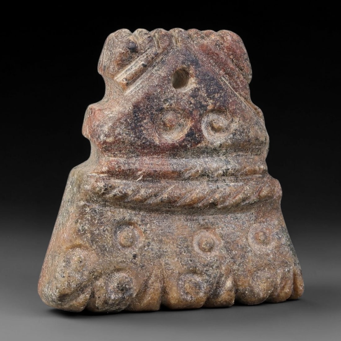 Ancient Ubaid-Mesopotamian Ornate Carved Stone Pendant Amulet (4500-3500 BCE), 98AJ: This ancient ornate carved stone pendant amulet originates from Ubaid-Mesopotamian cultural sphere, crafted as a wearable apotropaic ritual ornament. The tiered trapezoidal-form pendant features drill