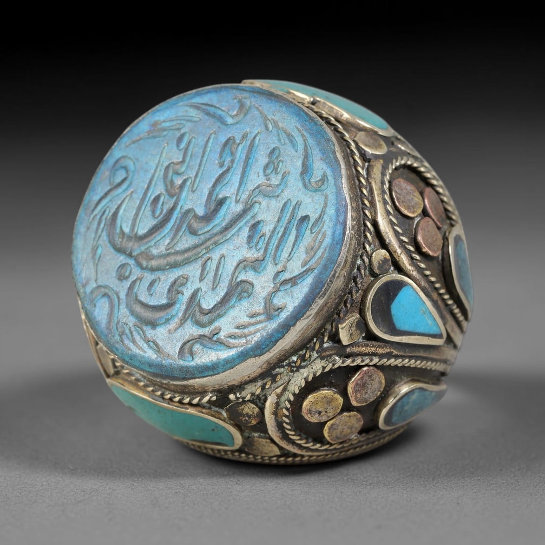 Vintage Islamic Handcrafted Silver Plated Calligraphic Talisman Statement Ring, 43AJ: This vintage hand-wrought Islamic statement ring features a central engraved panel bearing traditional calligraphic detailing, set within an ornate silver-plated metal band. The mounting is enriched w