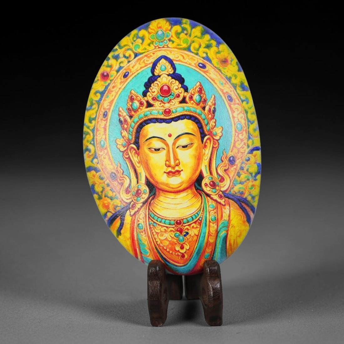 A Tibetan Thangka Style Painted River Stone with a Bodhisattva Figure, 60BC: Painted on a naturally rounded river stone, the work depicts a bodhisattva figure in a thangka-style composition. The figure is shown with a serene countenance, wearing an ornate jeweled crown inlaid 