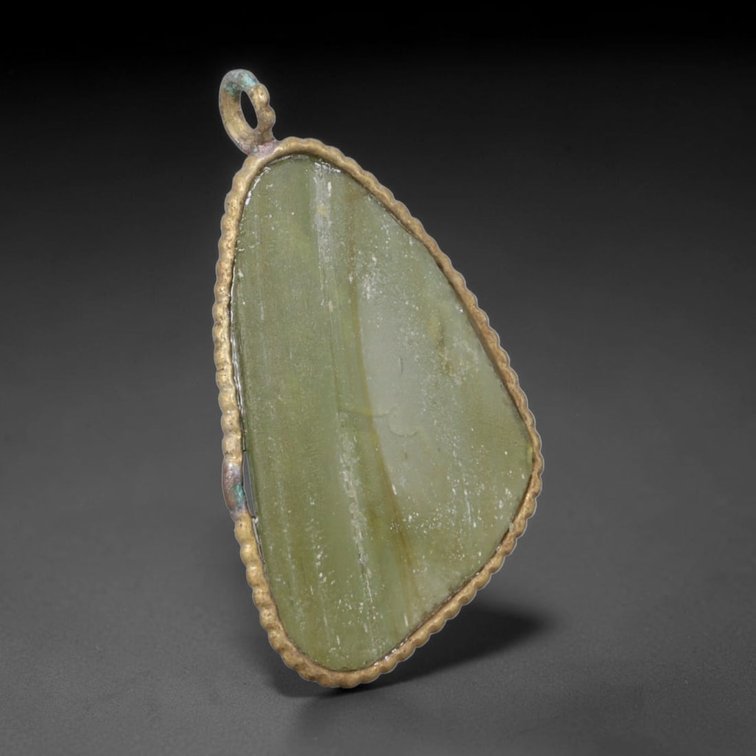 Ancient Roman Glass Slag in Modern Gilt-Edge Pendant, 69AK: This contemporary pendant is crafted from ancient Roman glass slag, featuring a fragmented, iridescent glass surface with weathered patina. The irregular form is bordered by a subtle gilt frame, added