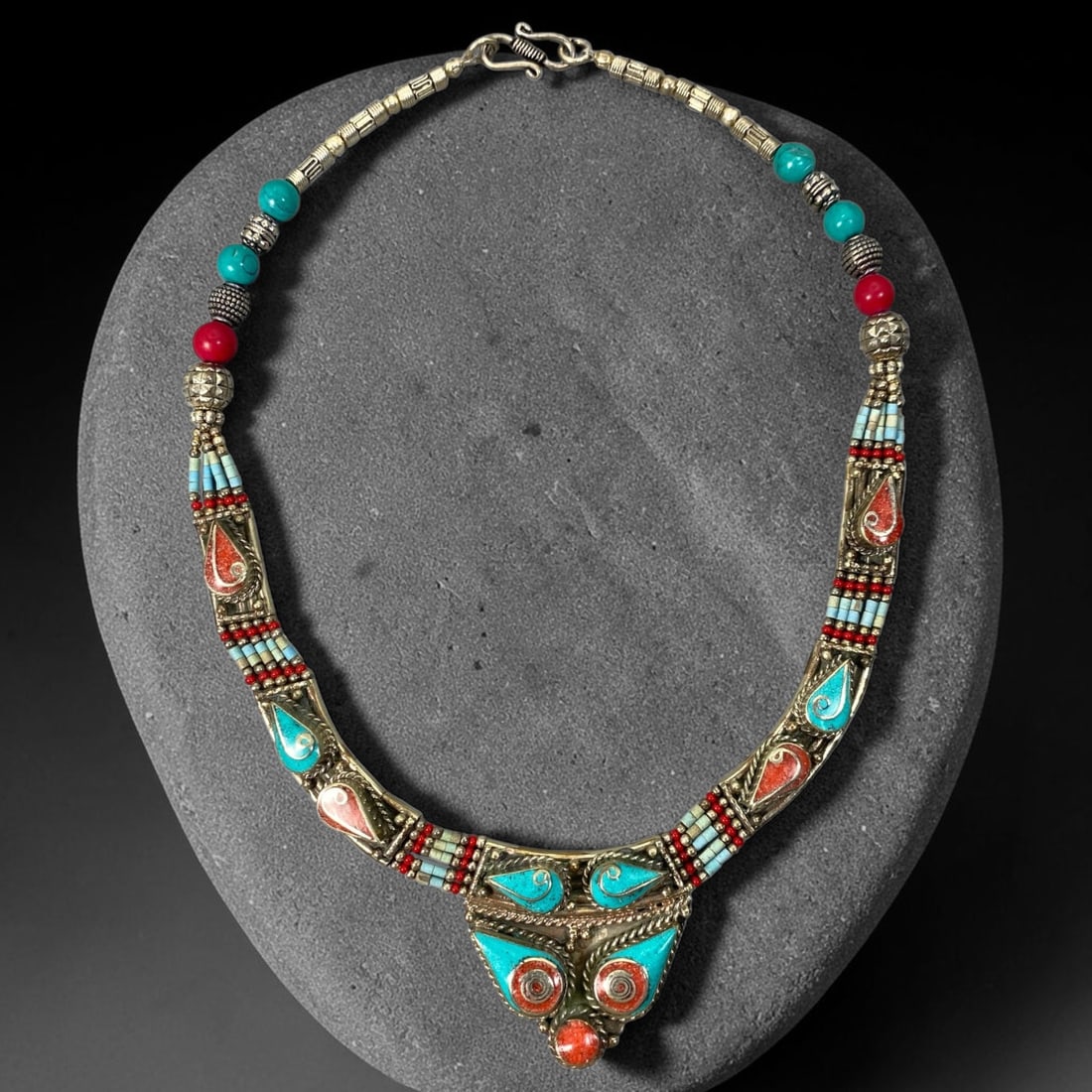A Central Asian Multi-Metal Multi-Stone Necklace, 5AL: Multi-metal necklace constructed with mixed spherical beads, textured metal beads and tubular metal links. The frontal curved panels incorporate teardrop-shaped stone inlays within bezel settings, int