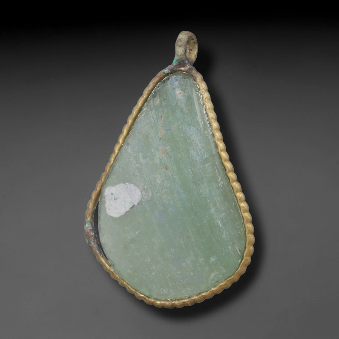 Ancient Roman Glass Slag in Modern Gilt-Edge Pendant, 89AK: This contemporary pendant is crafted from ancient Roman glass slag, featuring a fragmented, iridescent glass surface with weathered patina. The irregular form is bordered by a subtle gilt frame, added