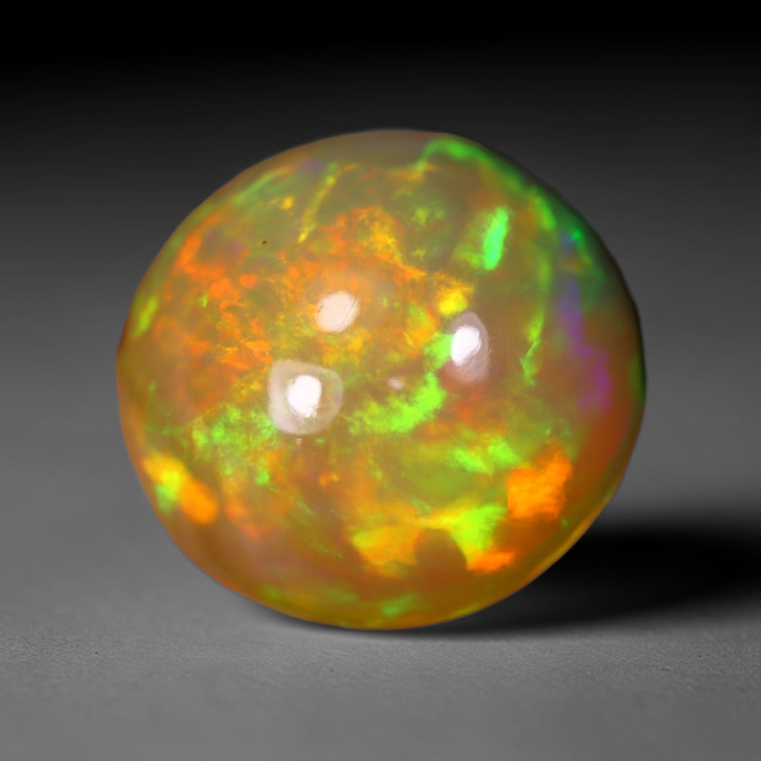 *6.38Ct Welo Opal Polished - Ethiopian Opal , 402C: No Reserve Gems Auction Subject: Natural Ethiopian Welo Opal Origin: Ethiopia Carat Weight: 6.38Ct Dimension: 14.2x14.1x7.2 mm Treatment: Natural Untreated Type: Cabochon, Polished