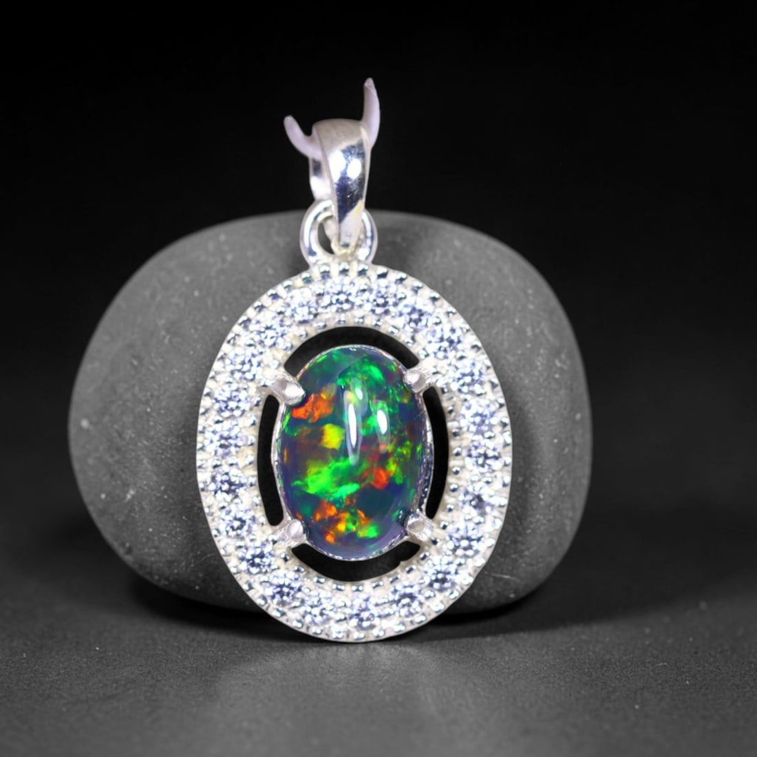 Silver Pendant with Ethiopian Black Opal 3.5grams - 925 Sterling Silver , 412E: No Reserve Gems Auction Subject: Opal & Simulated Diamond Silver Pendant Carat Weight: 3.5 grams (approx.) Dimension: Opal 10x7mm, Pendant 22x15mm