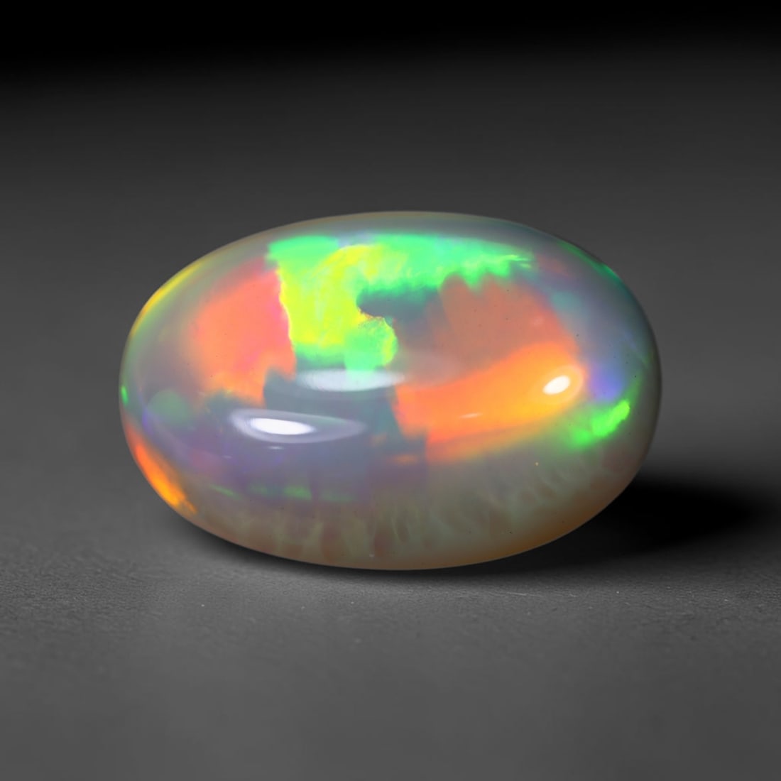 *6.49Ct Welo Opal Polished - Ethiopian Opal , 409C: No Reserve Gems Auction Subject: Natural Ethiopian Welo Opal Origin: Ethiopia Carat Weight: 6.49Ct Dimension: 16.5x11.2x7.1 mm Treatment: Natural Untreated Type: Cabochon, Polished