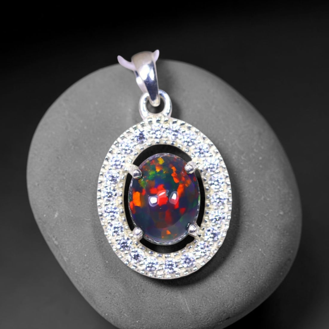 Silver Pendant with Ethiopian Black Opal 3.5grams - 925 Sterling Silver, 468B: No Reserve Gems Auction Subject: Opal & Simulated Diamond Silver Pendant Carat Weight: 3.5 grams (approx.) Dimension: Opal 10x7mm, Pendant 22x15mm
