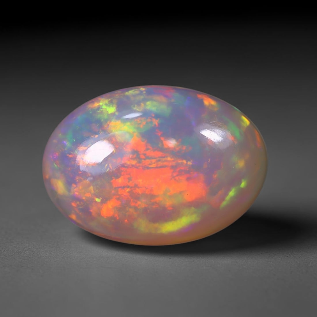 *7.81Ct Welo Opal Polished - Ethiopian Opal , 420C: No Reserve Gems Auction Subject: Natural Ethiopian Welo Opal Origin: Ethiopia Carat Weight: 7.81Ct Dimension: 16.2x11.6x8.1 mm Treatment: Natural Untreated Type: Cabochon, Polished