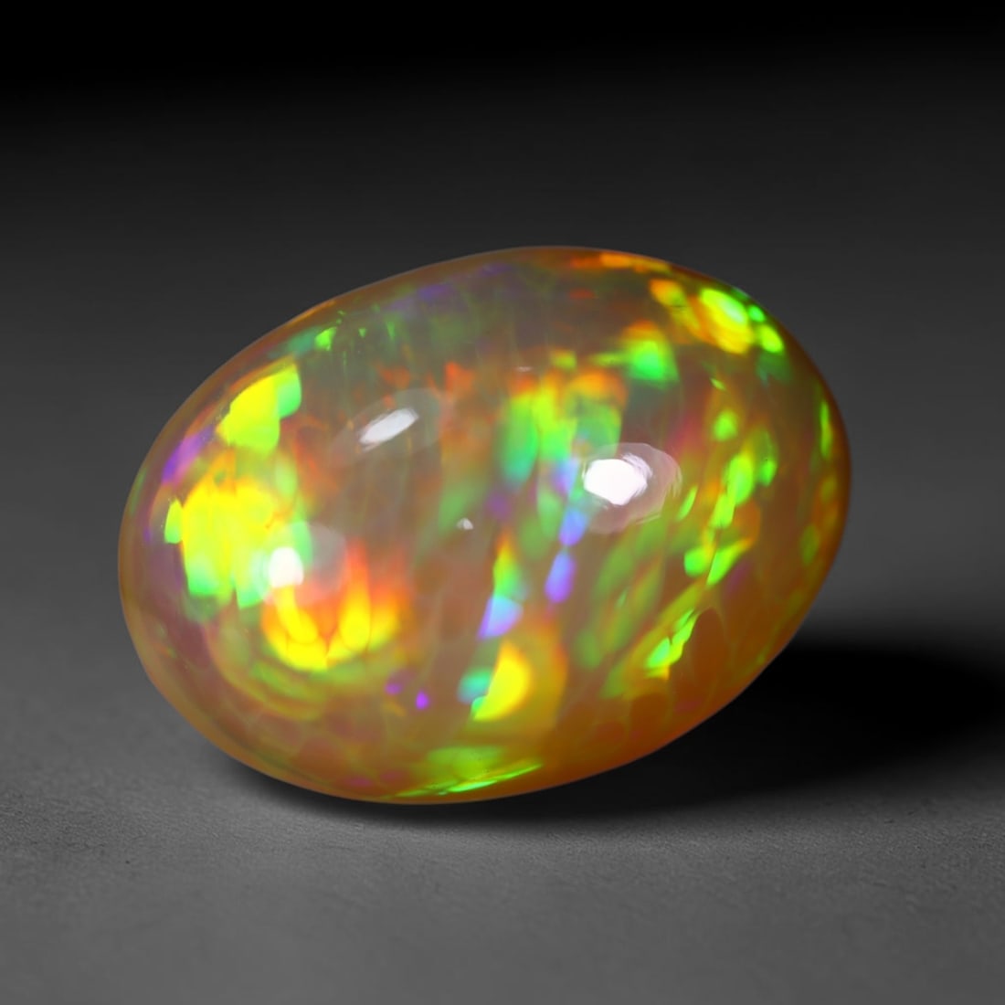 *11.56Ct Welo Opal Polished - Ethiopian Opal , 442C: No Reserve Gems Auction Subject: Natural Ethiopian Welo Opal Origin: Ethiopia Carat Weight: 11.56Ct Dimension: 19.5x13.8x9 mm Treatment: Natural Untreated Type: Cabochon, Polished