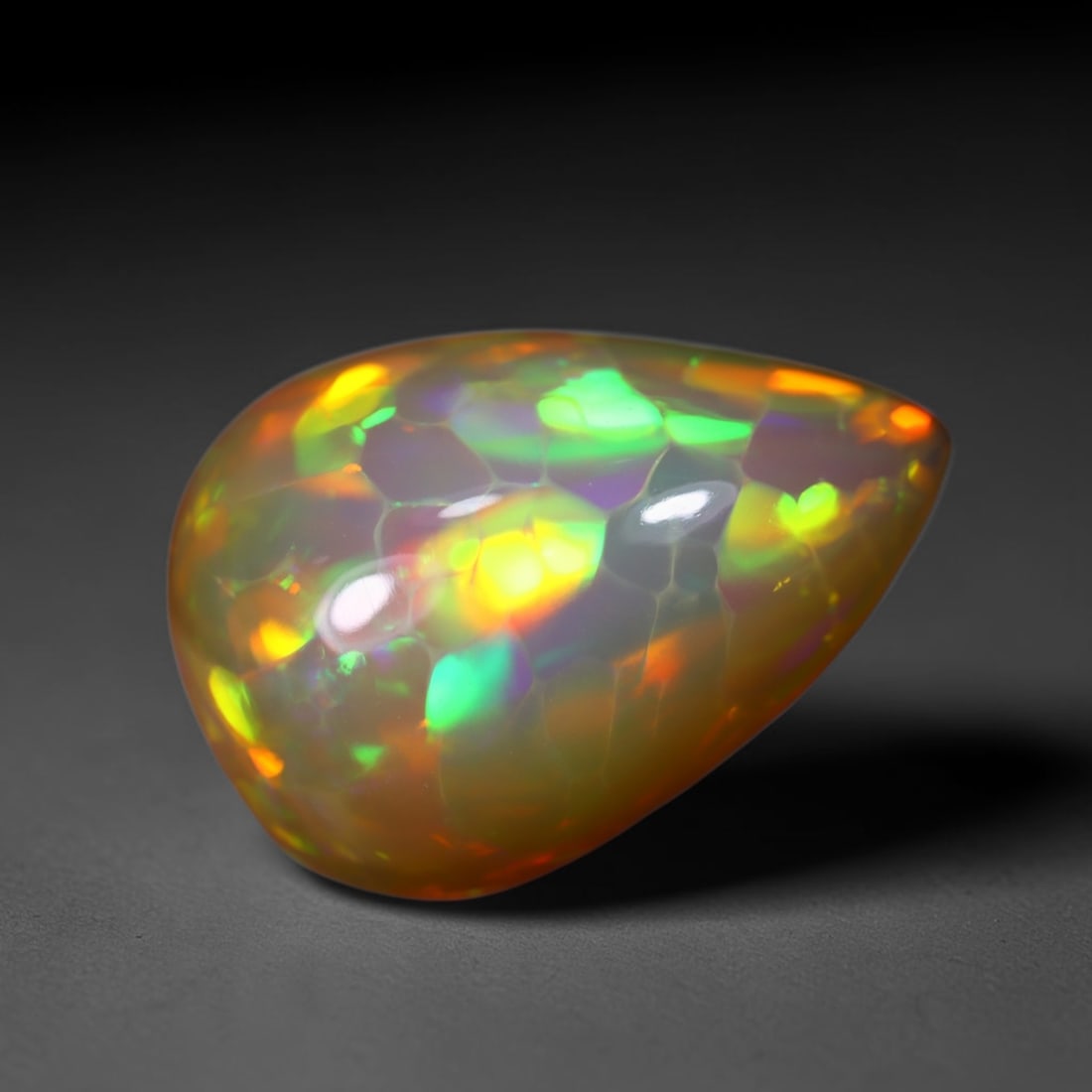 *8.69Ct Welo Opal Polished - Ethiopian Opal , 438C: No Reserve Gems Auction Subject: Natural Ethiopian Welo Opal Origin: Ethiopia Carat Weight: 8.69Ct Dimension: 19.6x13.7x8 mm Treatment: Natural Untreated Type: Cabochon, Polished
