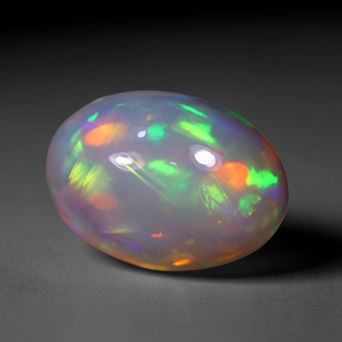 *10.95Ct Welo Opal Polished - Ethiopian Opal , 455C: No Reserve Gems Auction Subject: Natural Ethiopian Welo Opal Origin: Ethiopia Carat Weight: 10.95Ct Dimension: 17.1x12.3x10.4 mm Treatment: Natural Untreated Type: Cabocho