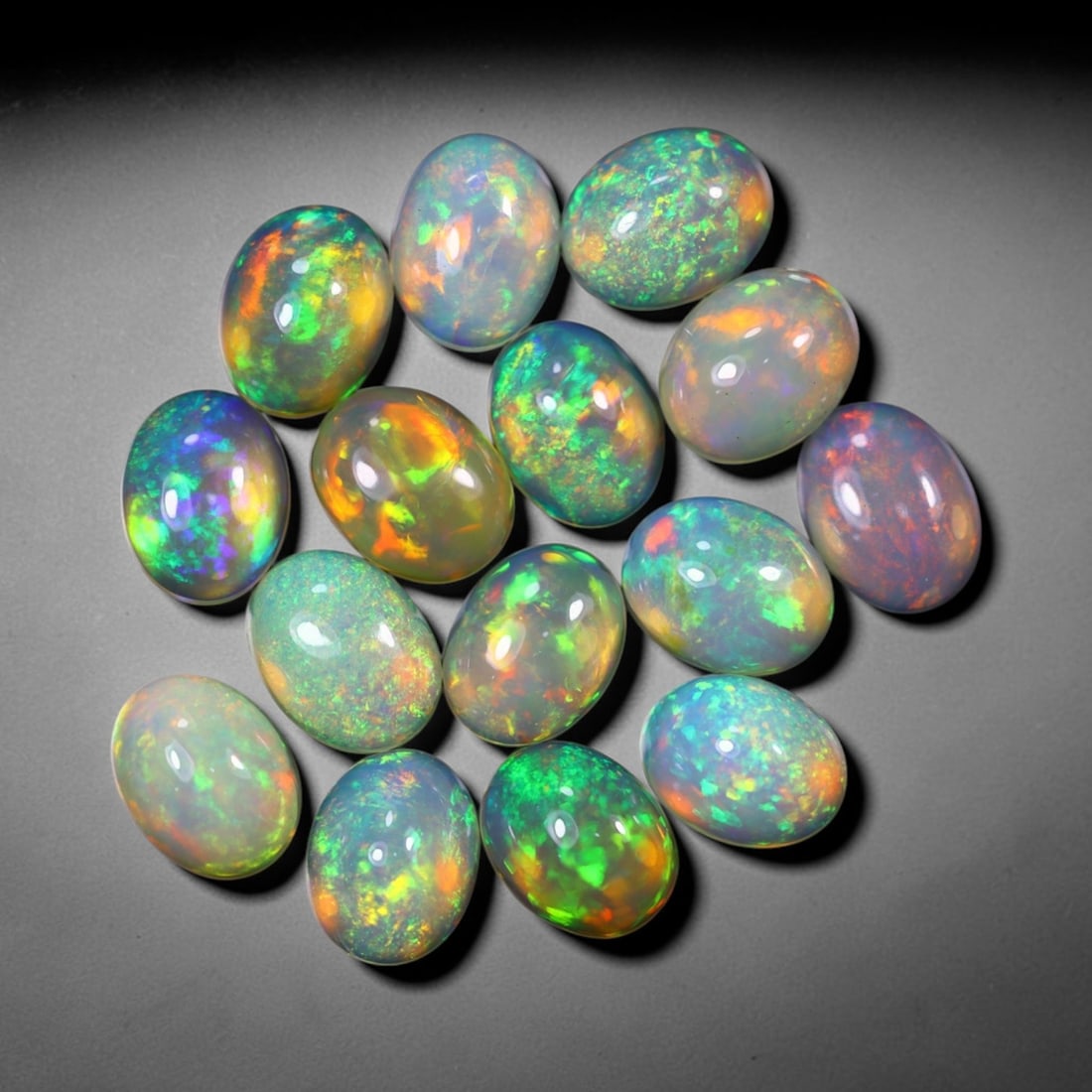 *18.89Ct 9x7mm Welo Opal Lot - Ethiopian Opal, 368C: No Reserve Gems Auction Subject: Natural Ethiopian Welo Opal Origin: Ethiopia Carat Weight: 18.89Ct Dimension: 9x7x4.5 mm Treatment: Natural Untreated Type: Cabochon, Polished