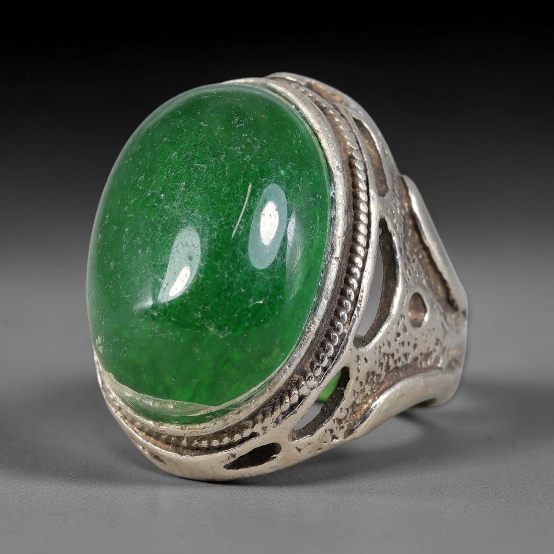Antique Ottoman Green Stone Beaded Border Pierced Openwork Silver Ring, 7AL: Silver ring of the Ottoman period set with an oval cabochon green stone within a beaded decorated bezel. The ring shoulders feature pierced openwork cutout detailing. No hallmarks present. Ring size 9