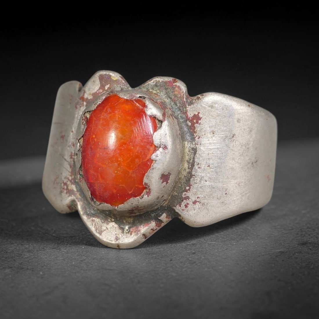 Antique Ottoman Carnelian Scalloped Bezel Silver Ring, 39AL: Silver ring of the Ottoman period set with an oval cabochon carnelian secured within a hand-formed scalloped bezel. The wide shank features flared, shaped shoulders with residual surface patina and we