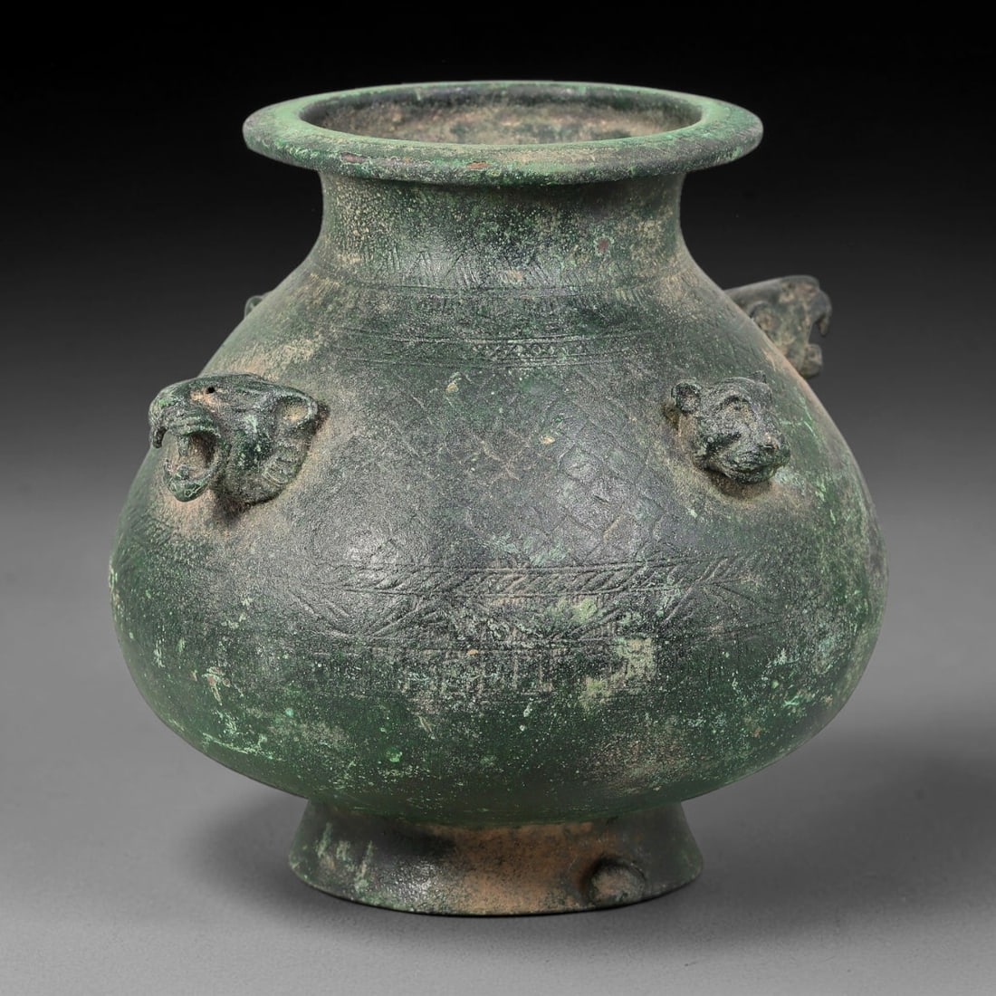 Ancient Sasanian Persian Bronze Feline Zoomorphic Vessel (c.224-651 CE), 34AL: Ancient Sasanian Persian bronze vessel adorned with four projecting feline zoomorphic heads around the bulbous body, with incised decorative surface detail and stable deep green ancient patina. Dimens