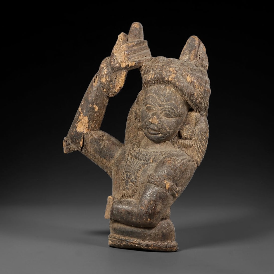 Antique Indo-Pacific Wood Deity Figure Figurine, 99AK: Carved wood figurine depicting a deity with one arm raised and the other held across the torso. The carving features defined facial detailing, stylised headdress, neck ornamentation and armbands. Exhi