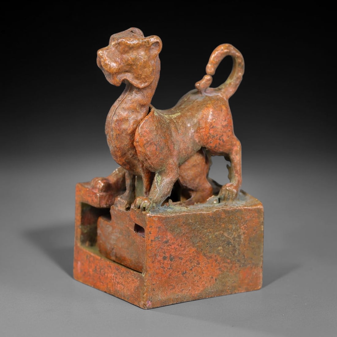 An Antique Chinese Bronze Interlocking Feline Seal, 43AL: Cast in bronze with mottled reddish-brown patina and scattered greenish surface encrustation, the object comprises a square outer seal block and a removable standing feline-form inner seal that slots 