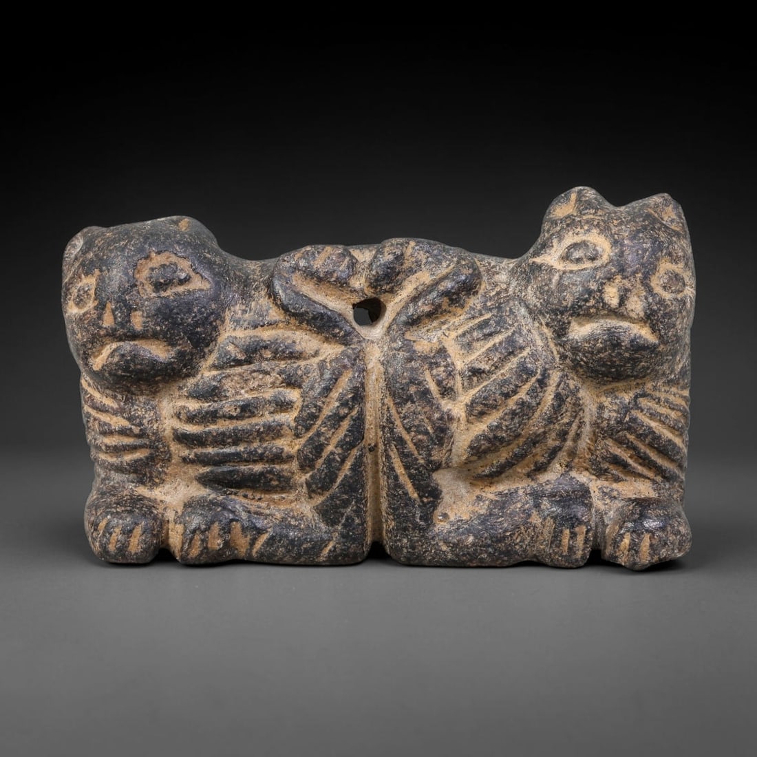 Ancient Neo-Hittite / Anatolian Bronze Age Double Zoomorphic Stone Plaque (2000-700 BCE), 31AK: This carved dark stone double-creature plaque originates from the Neo-Hittite / Anatolian Bronze Age cultures of ancient Anatolia, created as a wearable protective talisman for elite personal adornmen
