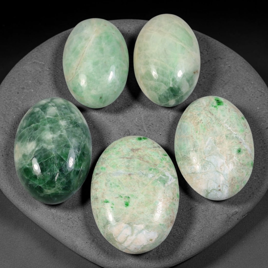 166ct Natural Burmese Type A Jadeite Jade Cabochon Parcel Lot, 60AL: This polished oval cabochon parcel displays natural Type A burmese jadeite jade with broad colour variation. High gloss polished domed surfaces reveal natural internal crystalline textures, mineral ve