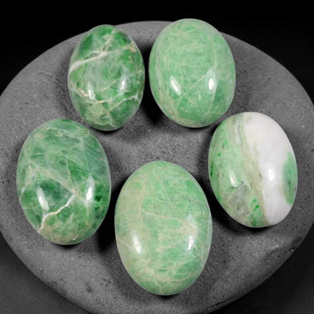 177ct Natural Burmese Type A Jadeite Jade Cabochon Parcel Lot, 57AL: This polished oval cabochon parcel displays natural Type A burmese jadeite jade with broad colour variation. High gloss polished domed surfaces reveal natural internal crystalline textures, mineral ve