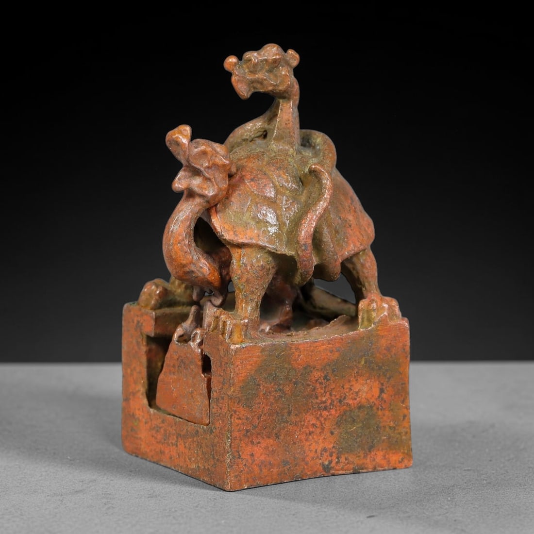 An Antique Chinese Bronze Interlocking Tortoise-Dragon Seal, 45AL: Cast in bronze with reddish-brown patina and scattered dark surface encrustation, the object is formed of a square outer seal matrix surmounted by a tortoise shell housing two dragon heads, together w