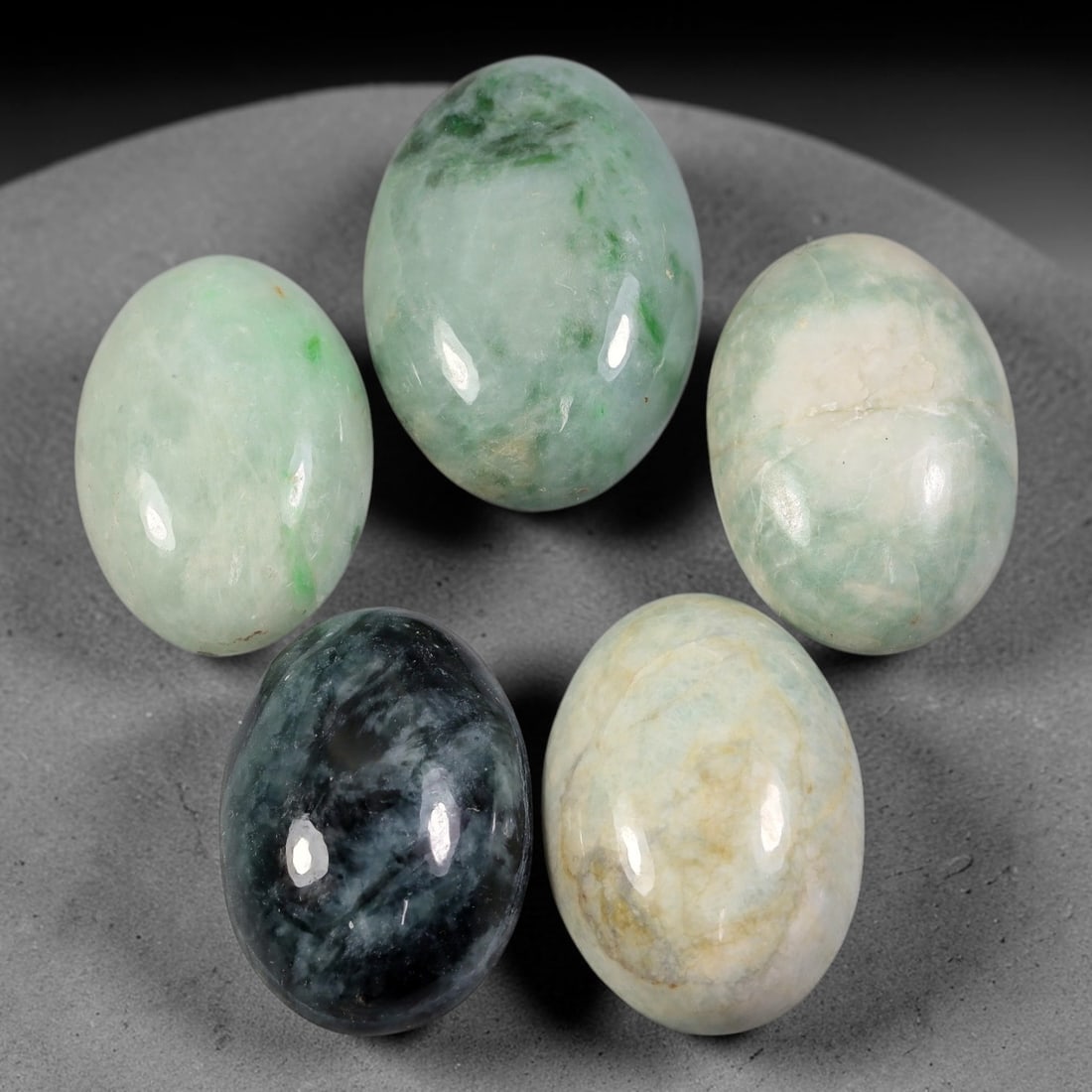 228ct Natural Burmese Type A Jadeite Jade Cabochon Parcel Lot, 55AL: This polished oval cabochon parcel displays natural Type A burmese jadeite jade with broad colour variation. High gloss polished domed surfaces reveal natural internal crystalline textures, mineral ve