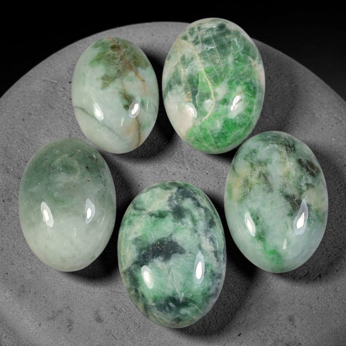 205ct Natural Burmese Type A Jadeite Jade Cabochon Parcel Lot, 59AL: This polished oval cabochon parcel displays natural Type A burmese jadeite jade with broad colour variation. High gloss polished domed surfaces reveal natural internal crystalline textures, mineral ve