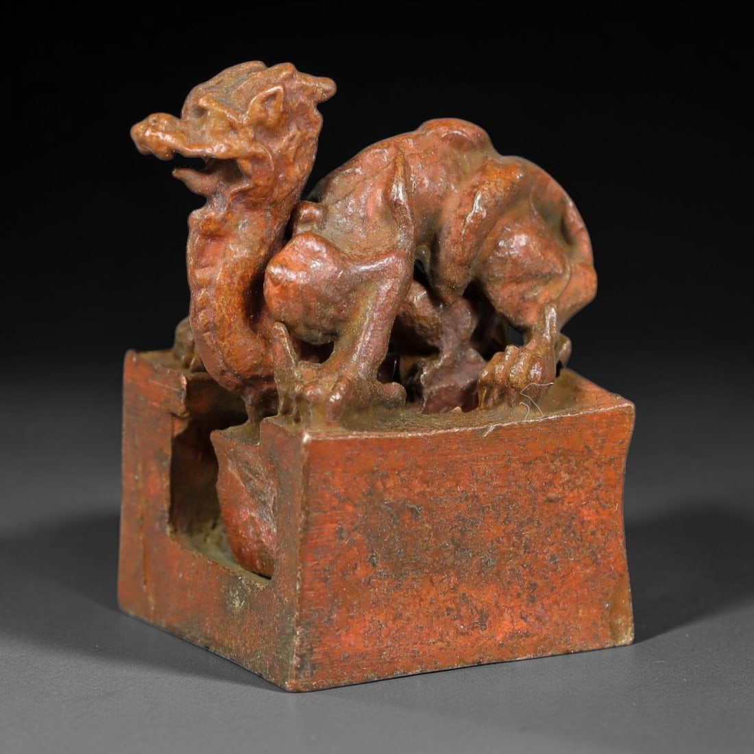 An Antique Chinese Bronze Interlocking Dragon Seal, 46AL: Cast in bronze with rich reddish-brown surface patina, the object comprises a square outer seal matrix and a removable zoomorphic dragon seal element that slots within the frame. The dragon is modelle