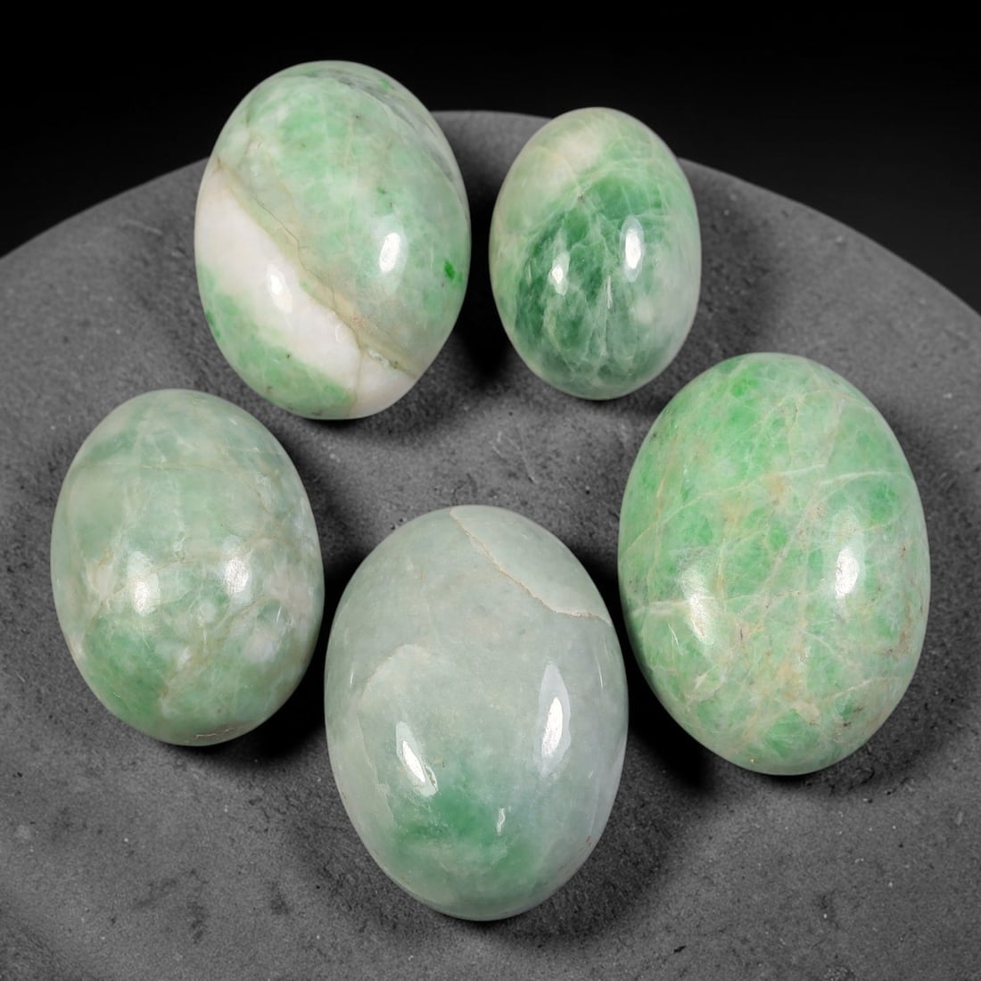224ct Natural Burmese Type A Jadeite Jade Cabochon Parcel Lot, 56AL: This polished oval cabochon parcel displays natural Type A burmese jadeite jade with broad colour variation. High gloss polished domed surfaces reveal natural internal crystalline textures, mineral ve