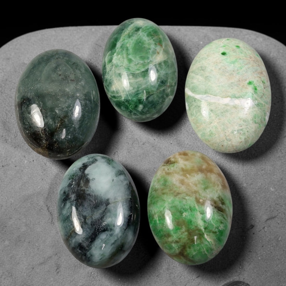 209ct Natural Burmese Type A Jadeite Jade Cabochon Parcel Lot, 53AL: This polished oval cabochon parcel displays natural Type A burmese jadeite jade with broad colour variation. High gloss polished domed surfaces reveal natural internal crystalline textures, mineral ve