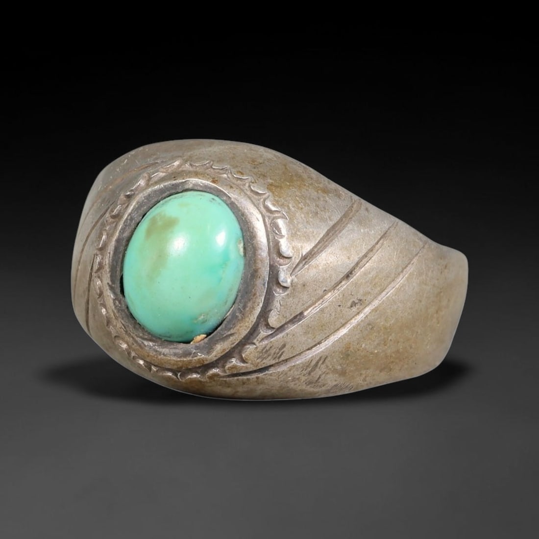 Antique Ottoman Turquoise Curved Incised Bezel Silver Ring, 27AL: Silver ring of the Ottoman period set with an oval cabochon turquoise within a curved scalloped incised bezel. The ring shank bears parallel slanted engraved lines across the shoulders. No hallmarks p