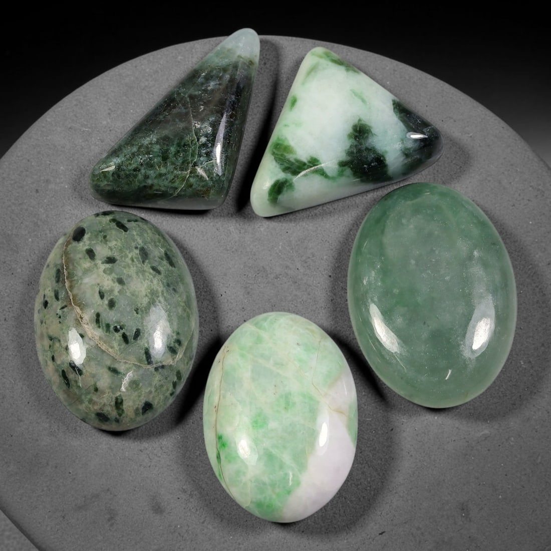 174ct Natural Burmese Type A Jadeite Jade Cabochon Parcel Lot, 54AL: This polished oval cabochon parcel displays natural Type A burmese jadeite jade with broad colour variation. High gloss polished domed surfaces reveal natural internal crystalline textures, mineral ve