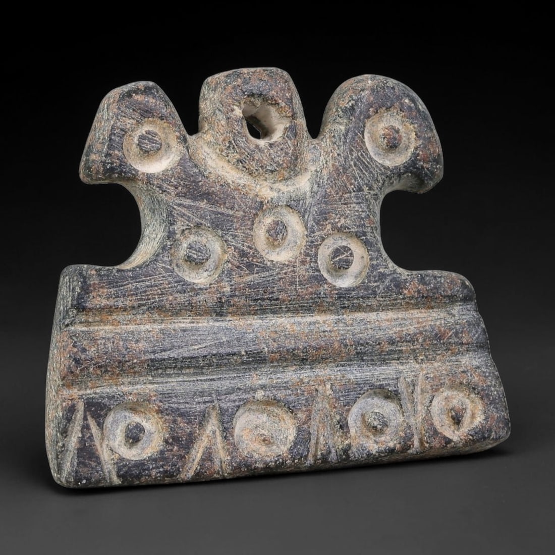 Ancient Ubaid-Mesopotamian Tri-Crested Stone Pendant Amulet (4500-3500 BCE), 86AJ: This ancient tri-crested stone pendant amulet originates from Ubaid-Mesopotamian cultural sphere, produced as a wearable apotropaic ritual ornament. The stylized three-lobed crest form features a cent