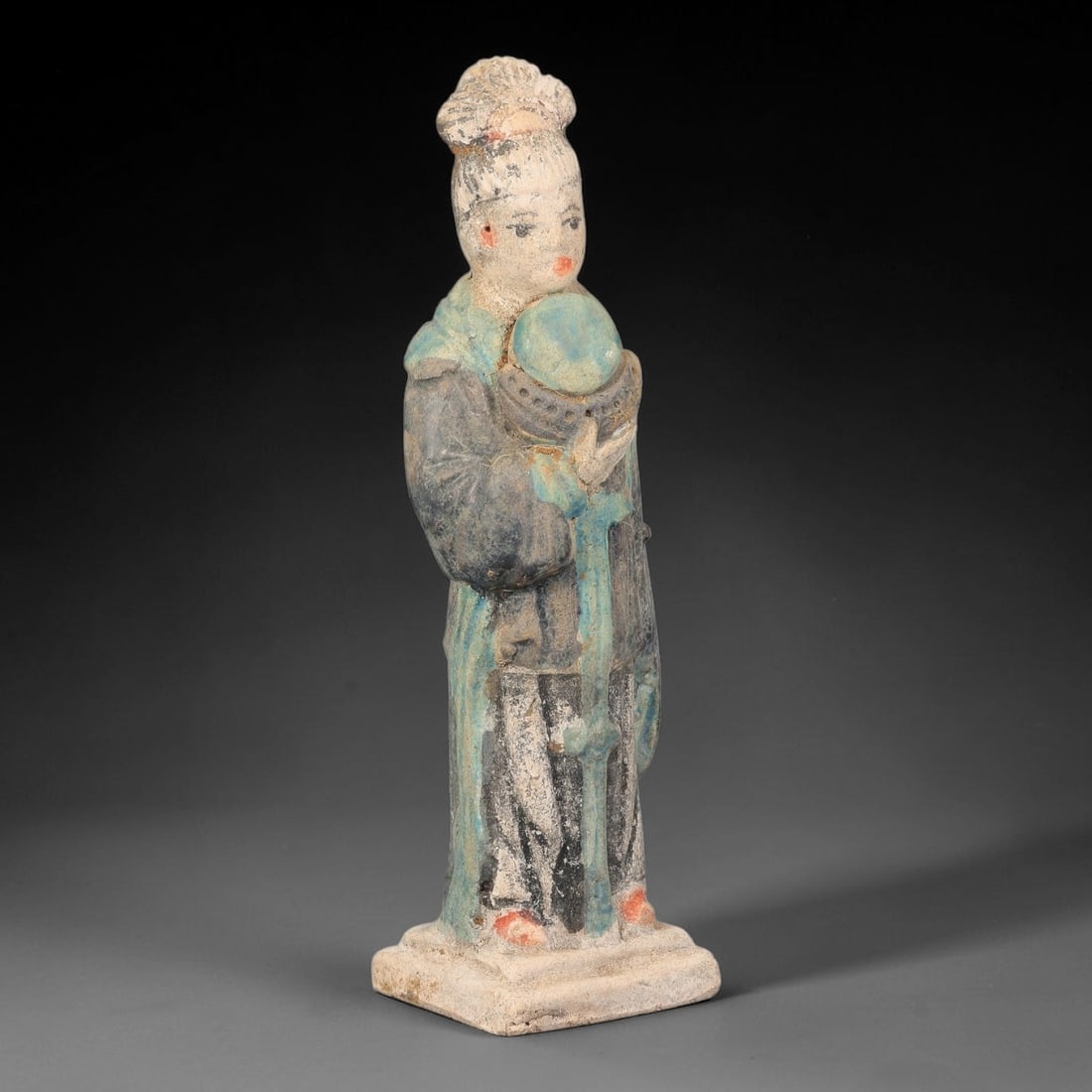 A Chinese Ming Dynasty Glazed Terracotta Female Attendant Figurine, 78AL: Modelled in hollow terracotta, the standing attendant is finished with polychrome pigment and glaze. The figure bears an elaborate coiffure, with defined facial features and pigmented lips and cheeks.