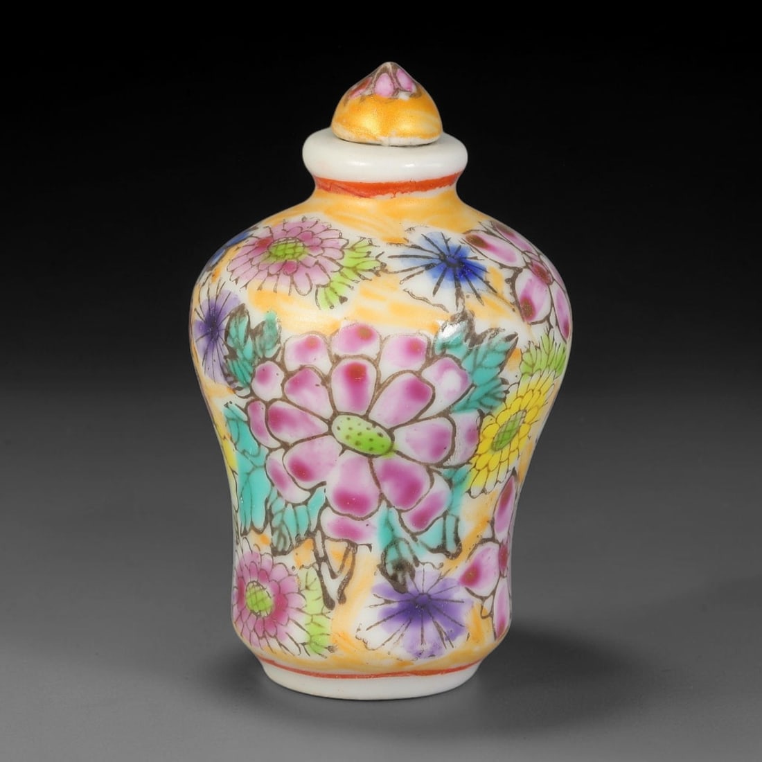 A Chinese Porcelain Millefleur Enamel Snuff Bottle, 95AL: Mei-shaped porcelain snuff bottle decorated all over with a rich millefleur enamel pattern upon a warm golden-yellow ground, featuring colourful blooms and outlined foliage. Red enamel lines accent th