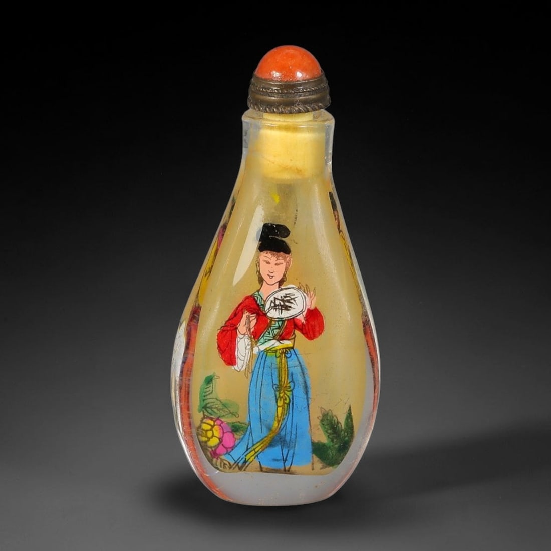 A Chinese Inside Painted Glass Snuff Bottle with Classical Ladies Motif, 2AV: Pear-shaped clear glass snuff bottle featuring fine interior painted scenes on both sides. One panel depicts a maiden holding a fan, while the reverse panel portrays a lady with blossoms, both rendere