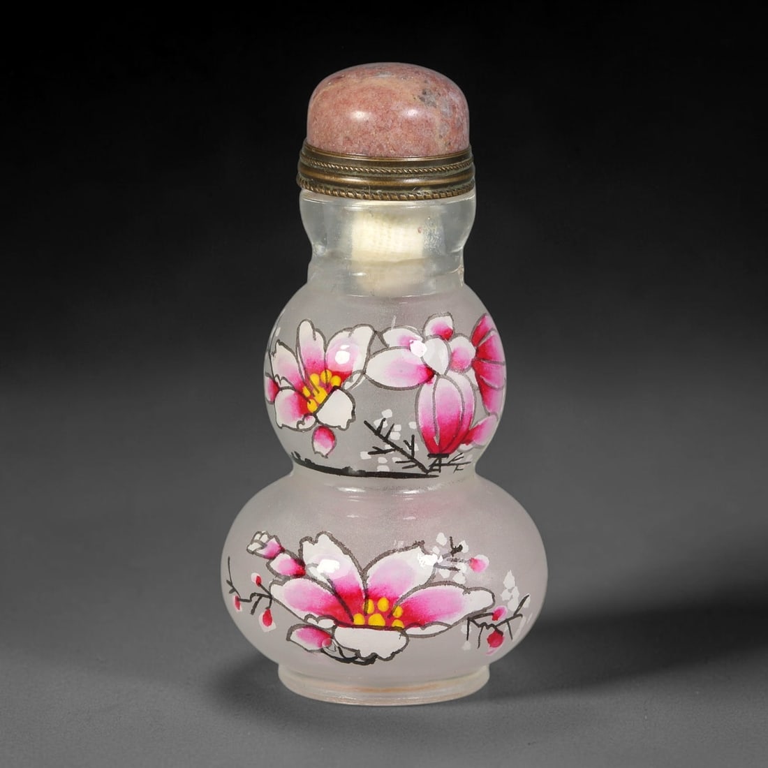 A Chinese Gourd Shaped Frosted Glass Enamel Magnolia Snuff Bottle, 42AV: Double-gourd form frosted glass snuff bottle decorated with hand-painted polychrome enamel magnolia blossoms and budding branches across both bulbous sections. The neck is fitted with twisted brass mo