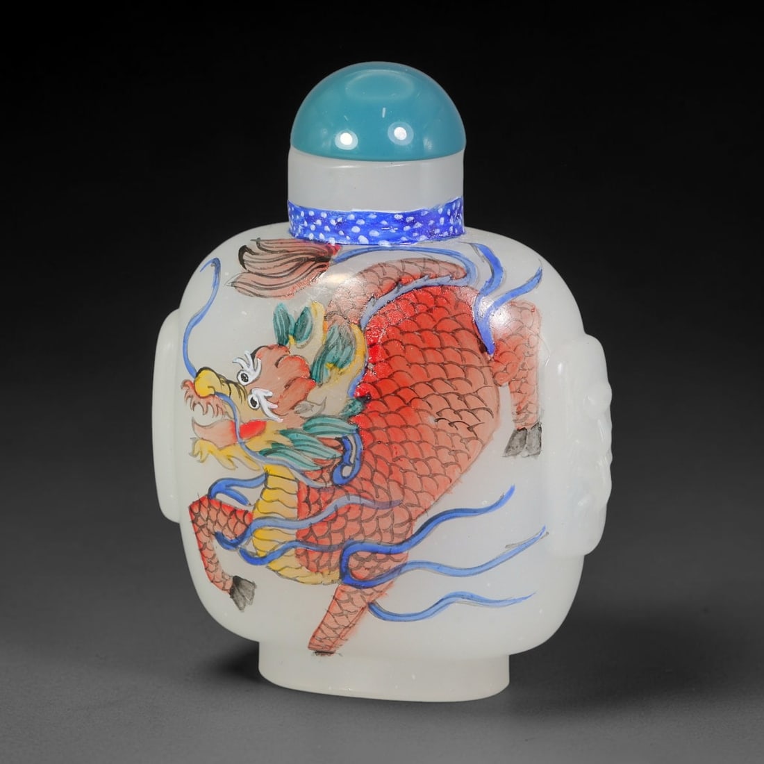 A Chinese White Glass Enamel Qilin Snuff Bottle, 92AL: Opaque white glass snuff bottle with moulded mask handles to the shoulders, decorated on each face with a hand-painted enamel qilin. One side depicts a red-scaled qilin with yellow chest and blue ribb