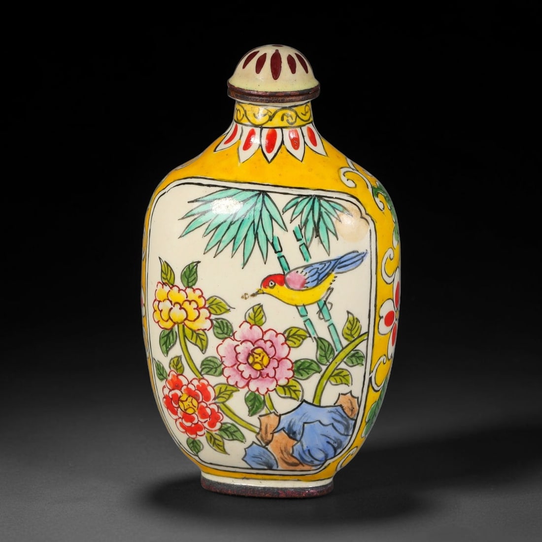 A Chinese Bronze Enamel Snuff Bottle with Bird and Floral Panels, 100AL: Rectangular flattened bronze snuff bottle decorated with vibrant enamel work. A bright yellow ground frames two reserved panels, one depicting a songbird perched amid peonies, bamboo and rockwork, the