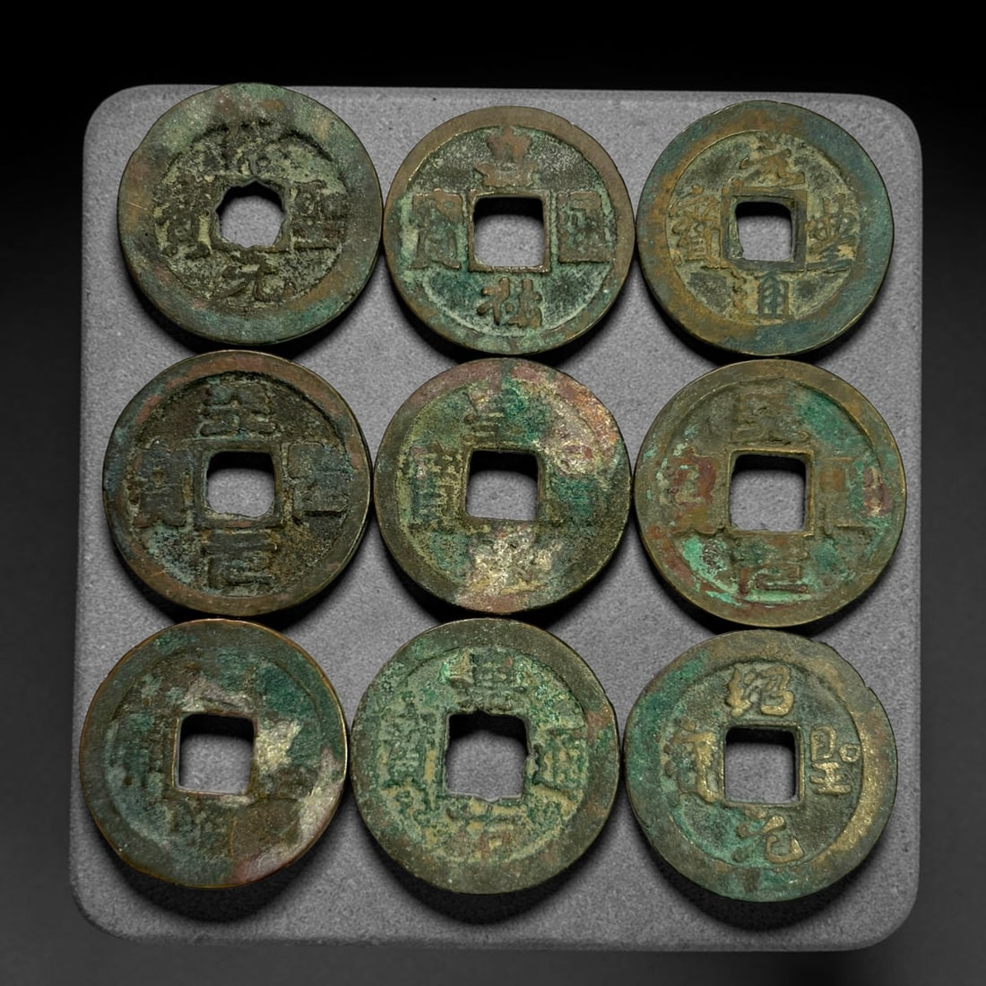Lot of 9 Ancient Chinese Song Dynasty Bronze Cash Coins, 41BD: A collection of nine bronze square-hole cash coins from the Song dynasty. Each coin bears inscribed coinage characters on the obverse, with varied patina, verdigris and earthen encrustation accumulate