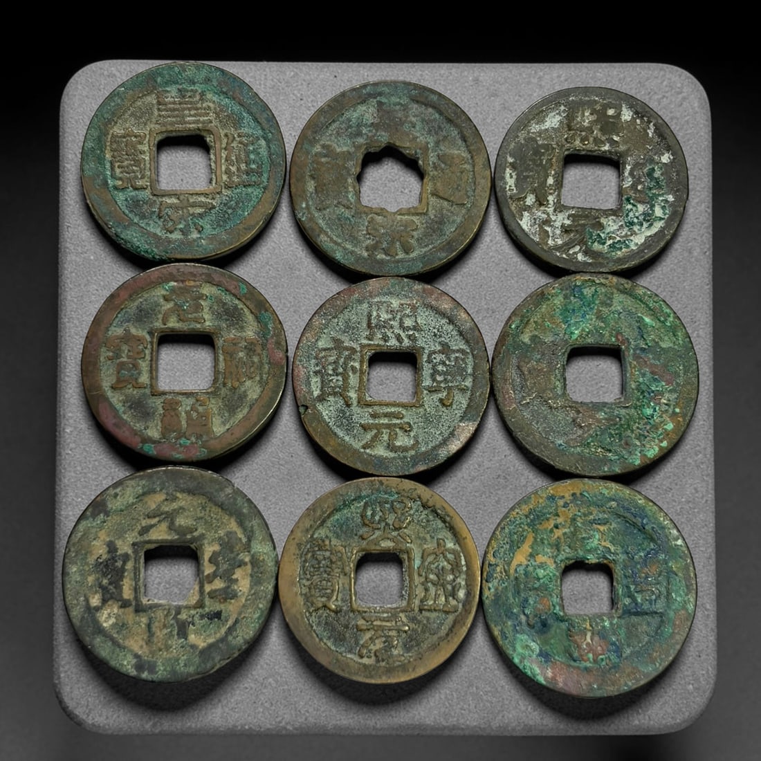 Lot of 9 Ancient Chinese Song Dynasty Bronze Cash Coins, 3BD: A collection of nine bronze square-hole cash coins from the Song dynasty. Each coin bears inscribed coinage characters on the obverse, with varied patina, verdigris and earthen encrustation accumulate