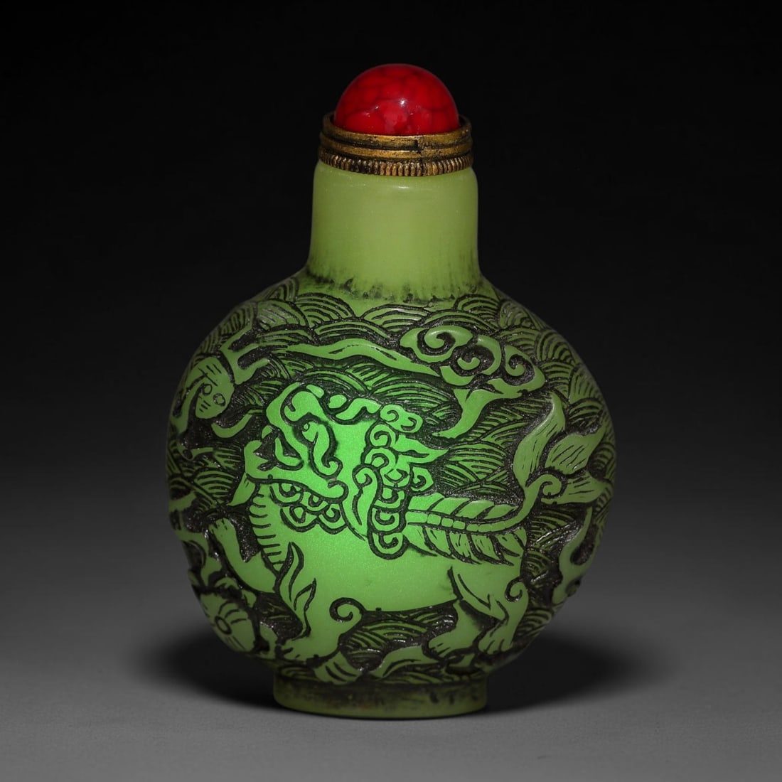 A Chinese Phosphorescent Green Relief Carved Qilin and Fu Lion Snuff Bottle, 87AV (1 of 2)