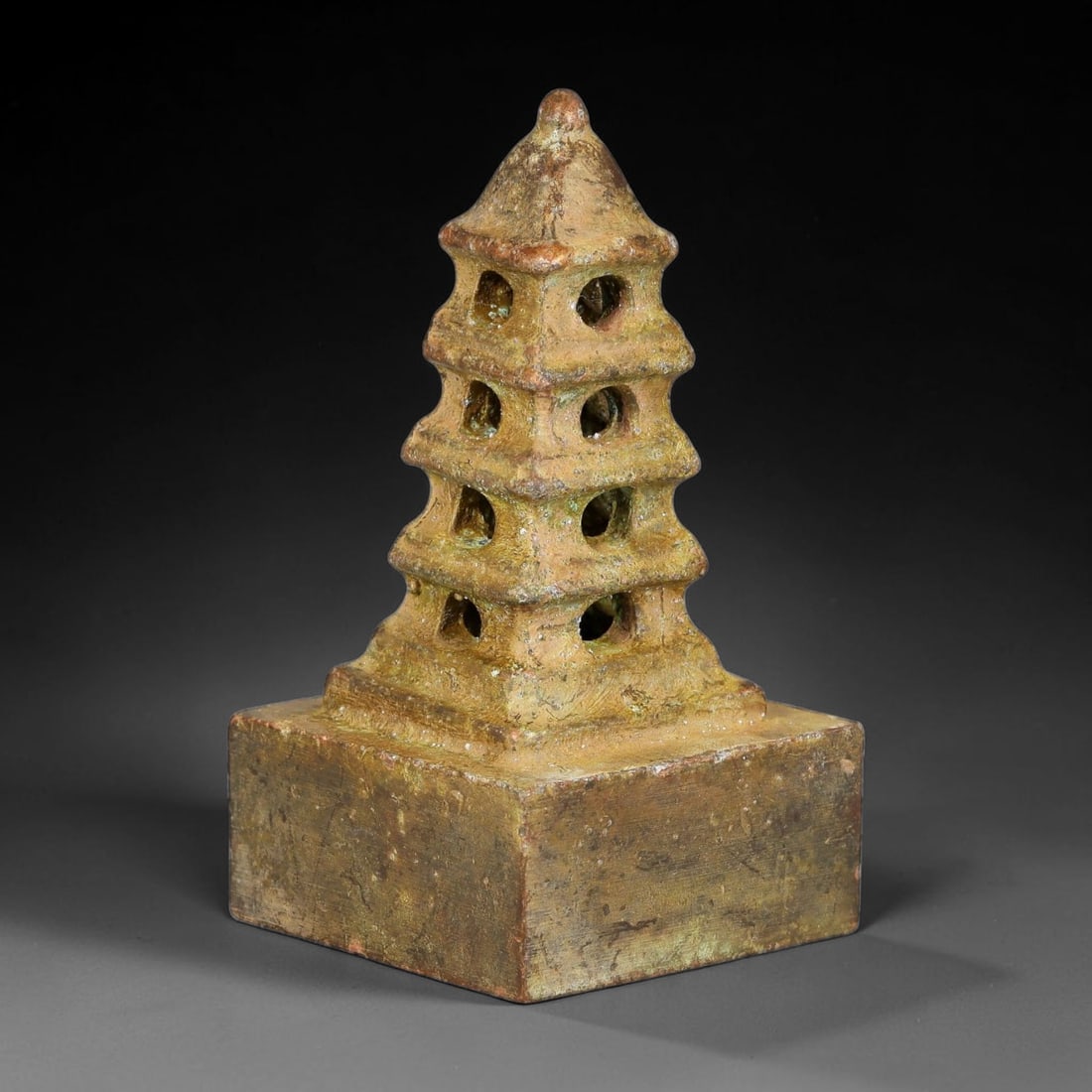 A Chinese Bronze Pagoda Finial Seal, 59AX: Cast bronze square seal topped with a multi-tiered pagoda finial with pierced window openings on each tier. The seal face bears deeply carved seal script characters. The bronze surface exhibits aged p